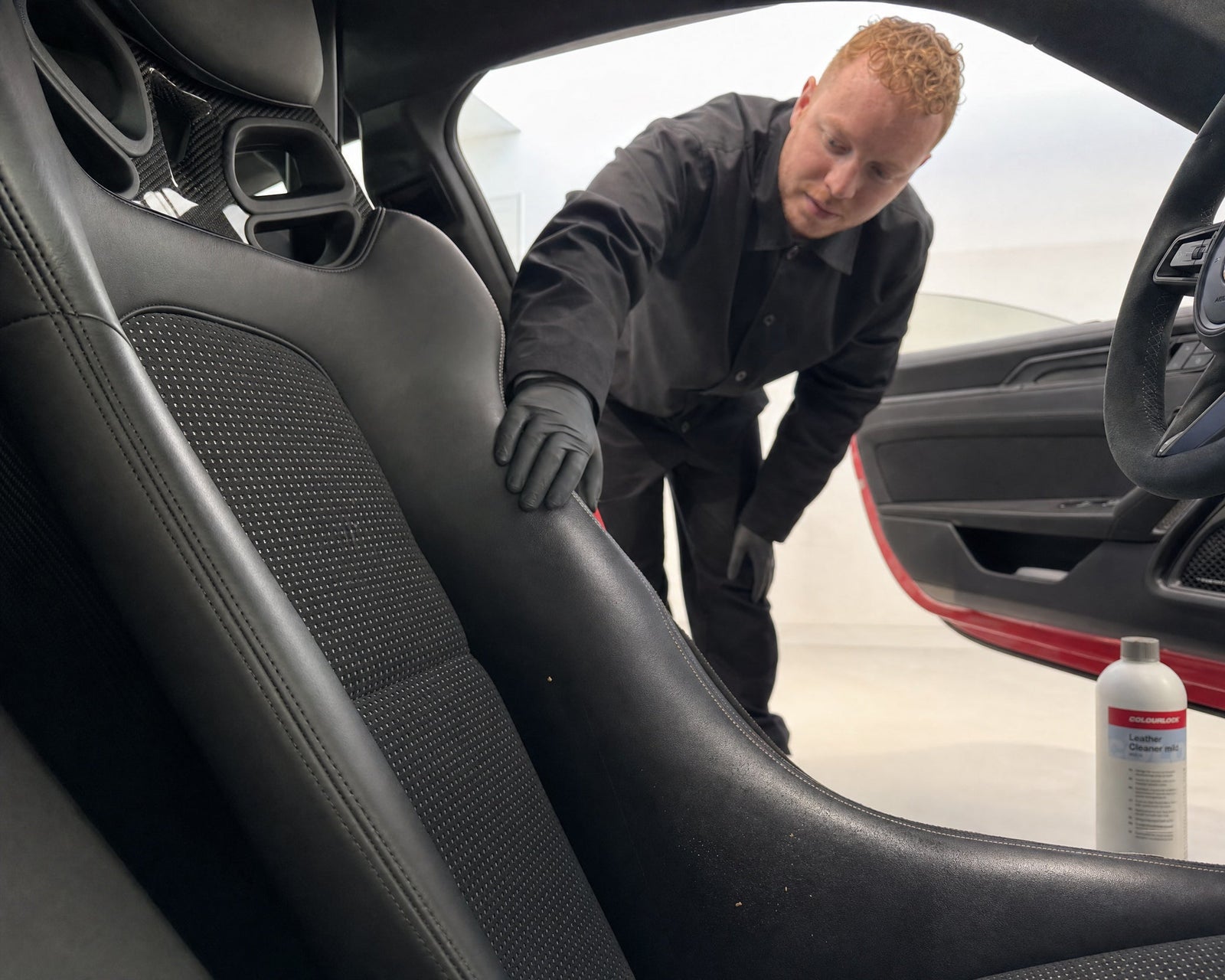 Benutzter Ledersitz im Porsche 911 GT3 RS mit COLOURLOCK Leather Cleaner mild 1 Liter daneben
